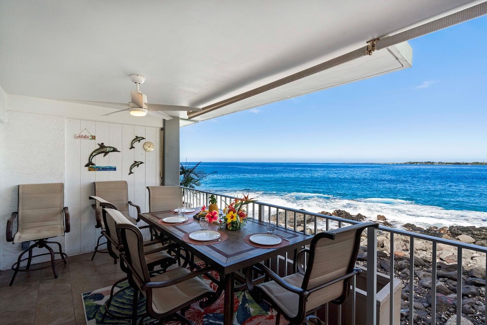 Vacation rental balcony with outdoor seating and ocean view