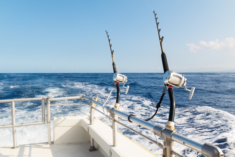 Two rods and reels in holders on a Hawaii charter boat