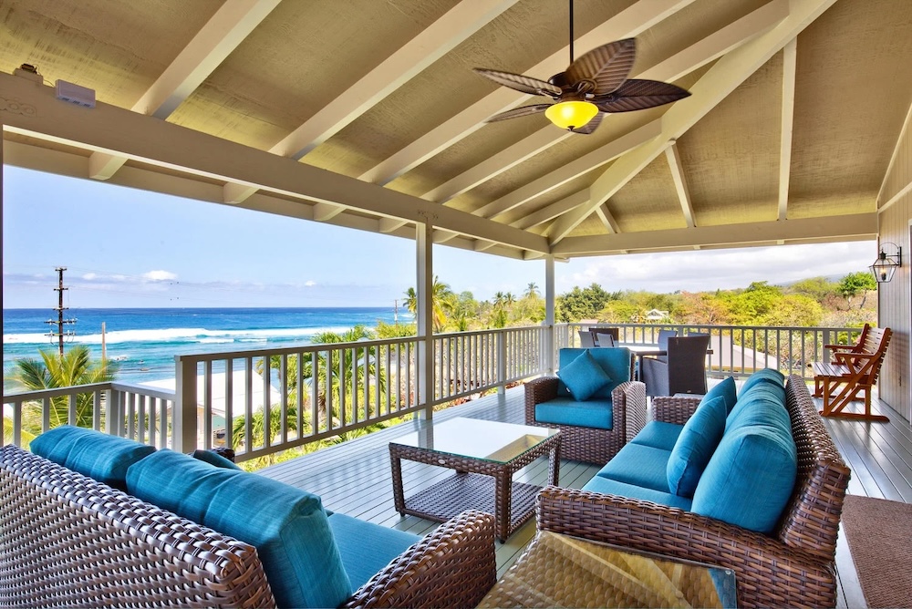 Vacation rental lanai with outdoor seating and ocean view